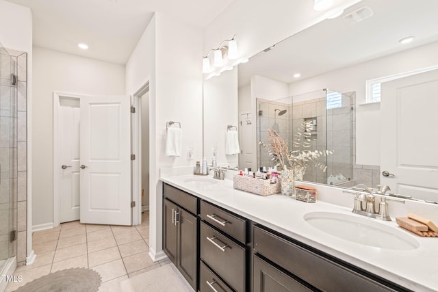2404 Azalea Dr, Durham, NC 27703 - full bath with a stall shower, tile patterned floors, and double vanity