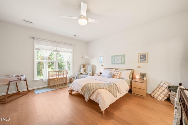 2404 Azalea Dr, Durham, NC 27703 - bedroom with light wood-type flooring, a ceiling fan, and baseboards