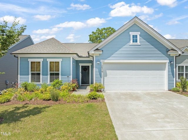 2404 Azalea Dr, Durham, NC 27703 - view of front facade with a garage, driveway, a front yard, and roof with shingles