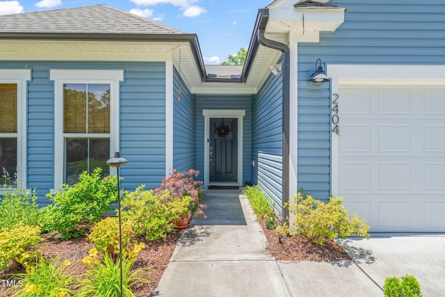 2404 Azalea Dr, Durham, NC 27703 - property entrance with a garage and a shingled roof