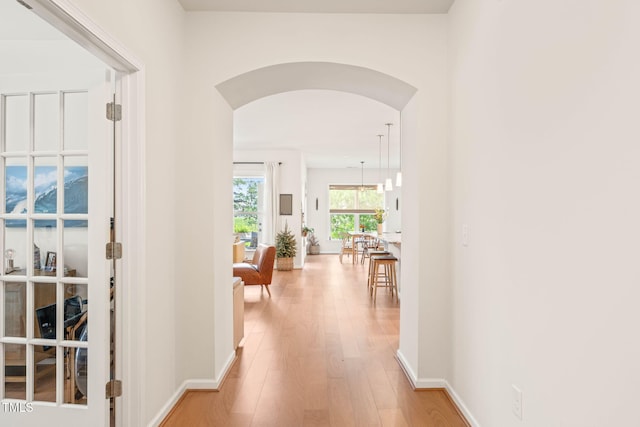 2404 Azalea Dr, Durham, NC 27703 - hall featuring arched walkways, wood finished floors, and baseboards