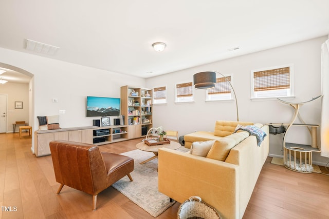 2404 Azalea Dr, Durham, NC 27703 - living room with arched walkways and light wood-style floors
