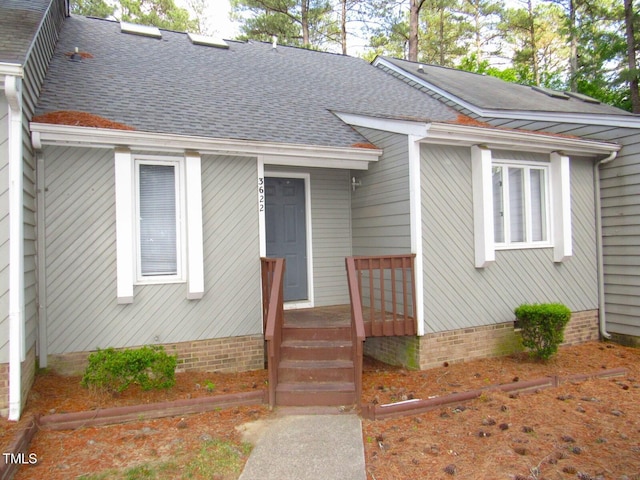 bungalow with roof with shingles and a deck
