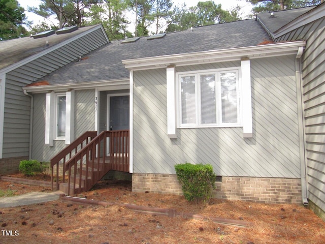 view of front of property featuring roof with shingles