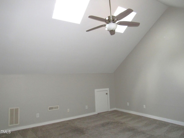 bonus room featuring visible vents, lofted ceiling with skylight, ceiling fan, and light colored carpet