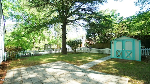 view of yard featuring a fenced backyard, a patio, an outdoor structure, and a shed