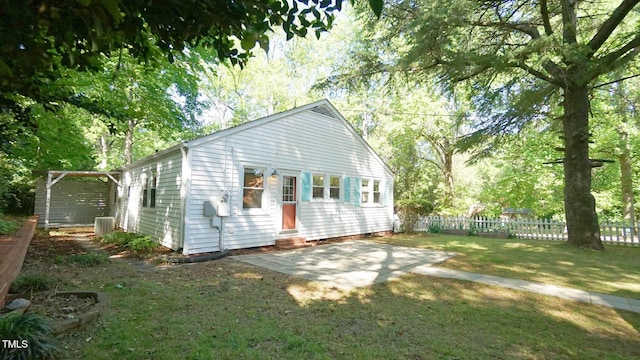 back of house with fence, a patio area, entry steps, a lawn, and central air condition unit