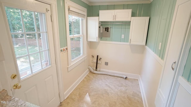clothes washing area featuring baseboards, cabinet space, and a wealth of natural light