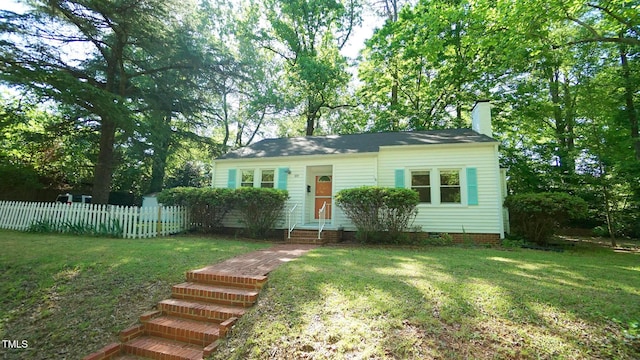 view of front of house with a front lawn, fence, crawl space, and a chimney