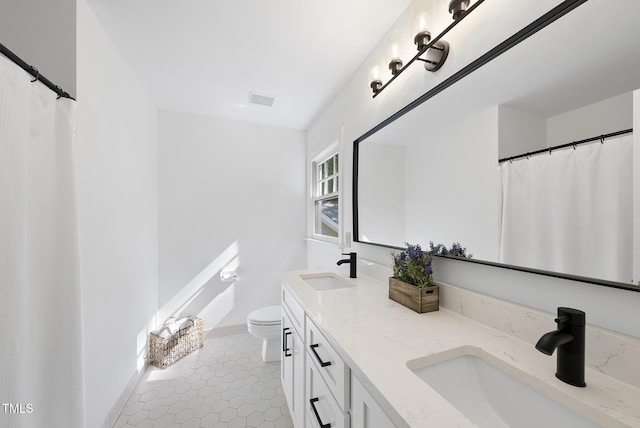 full bathroom featuring visible vents, a sink, tile patterned flooring, and toilet