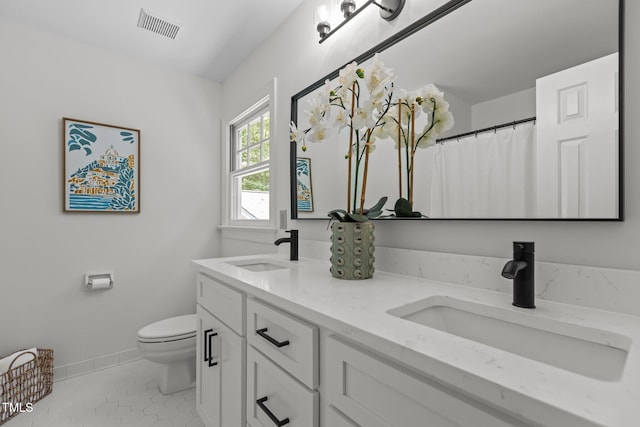 128 Cobblestone Dr, Chapel Hill, NC 27516 - full bath featuring double vanity, toilet, tile patterned floors, and baseboards