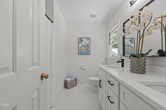 128 Cobblestone Dr, Chapel Hill, NC 27516 - full bathroom featuring toilet, double vanity, baseboards, and tile patterned floors