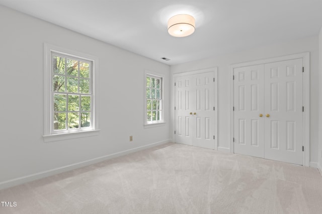 128 Cobblestone Dr, Chapel Hill, NC 27516 - unfurnished bedroom featuring two closets and carpet flooring