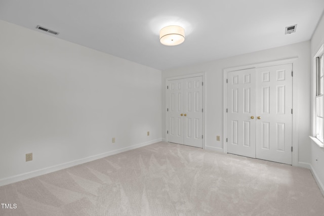 128 Cobblestone Dr, Chapel Hill, NC 27516 - unfurnished bedroom featuring two closets, carpet, and baseboards