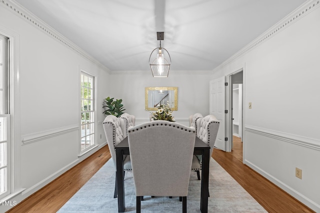128 Cobblestone Dr, Chapel Hill, NC 27516 - dining space with wood finished floors, crown molding, and baseboards