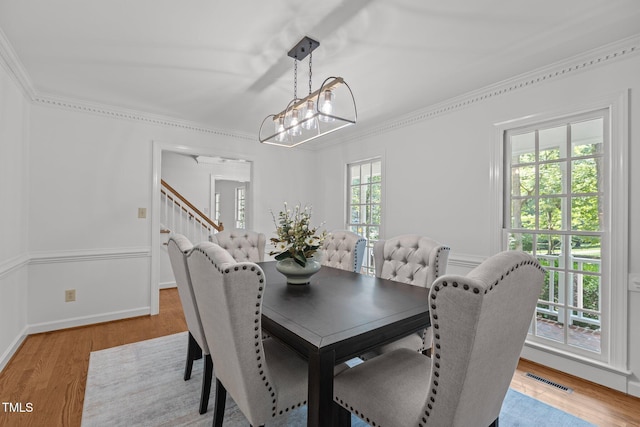 128 Cobblestone Dr, Chapel Hill, NC 27516 - dining area with ornamental molding, a chandelier, stairway, light wood finished floors, and baseboards
