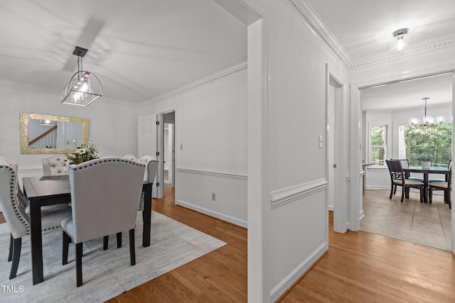 128 Cobblestone Dr, Chapel Hill, NC 27516 - dining area featuring a chandelier, wood finished floors, ornamental molding, and baseboards