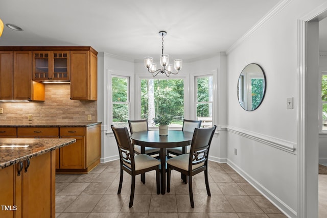 128 Cobblestone Dr, Chapel Hill, NC 27516 - dining area with a chandelier, light tile patterned floors, and crown molding