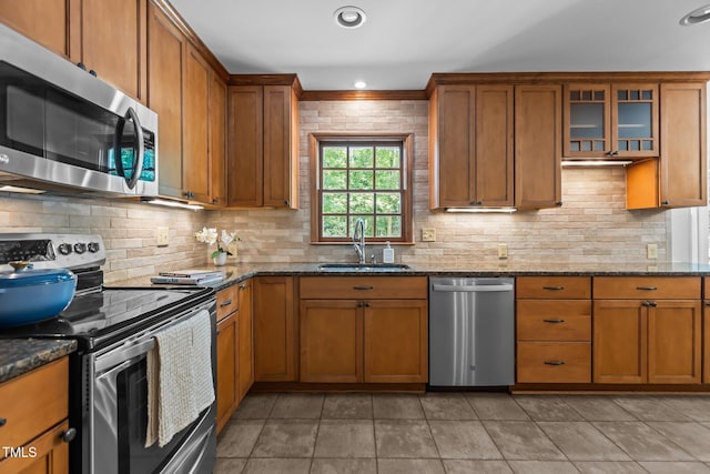 128 Cobblestone Dr, Chapel Hill, NC 27516 - kitchen featuring appliances with stainless steel finishes, a sink, brown cabinetry, and recessed lighting