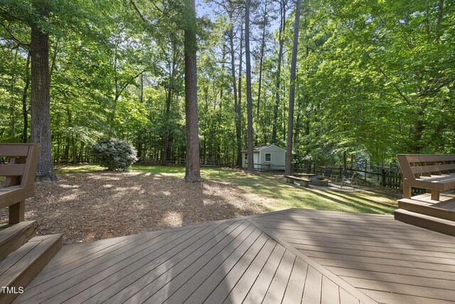 128 Cobblestone Dr, Chapel Hill, NC 27516 - wooden deck with an outdoor fire pit and an outbuilding