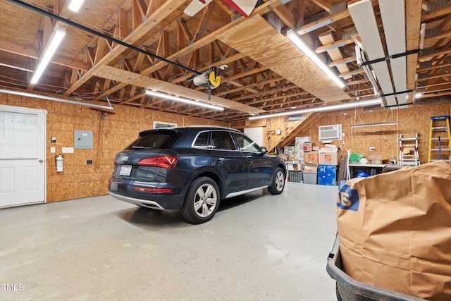 garage with a garage door opener and electric panel