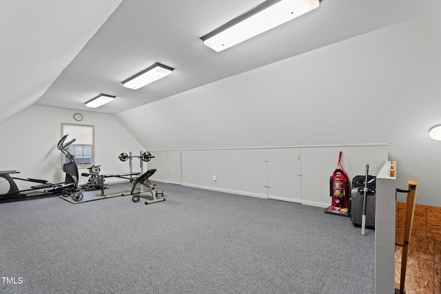 workout area featuring carpet floors, baseboards, and lofted ceiling