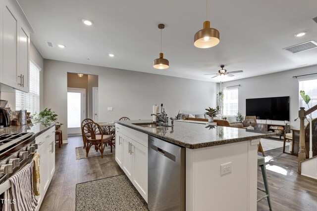 kitchen featuring a sink, visible vents, plenty of natural light, and dishwasher