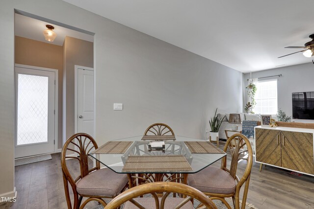 dining space featuring a ceiling fan and wood finished floors