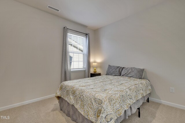 bedroom with baseboards, carpet flooring, and visible vents