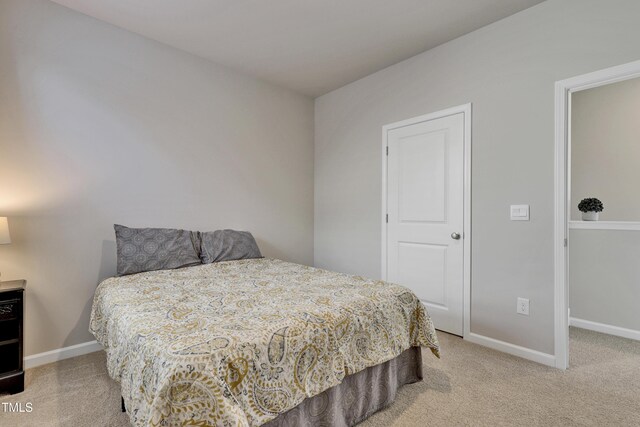 bedroom with carpet floors and baseboards