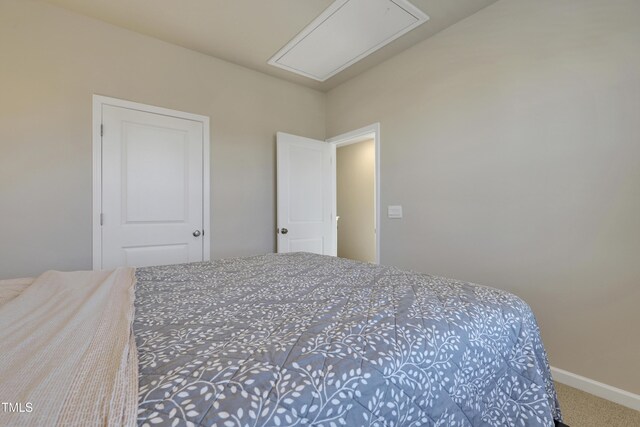 bedroom featuring carpet floors, attic access, and baseboards