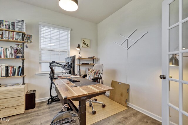 home office featuring baseboards and wood finished floors