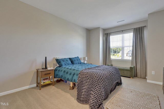 bedroom with carpet floors, baseboards, and visible vents