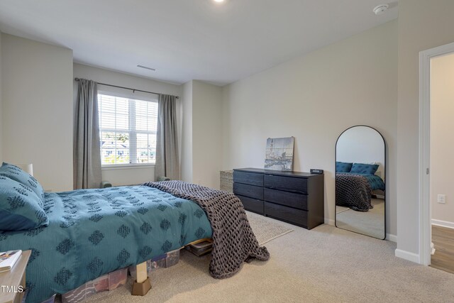 carpeted bedroom with baseboards and visible vents