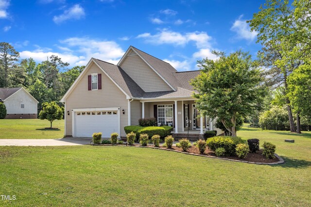traditional home with covered porch, a front yard, roof with shingles, concrete driveway, and an attached garage