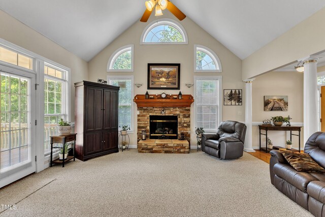 living room with light colored carpet, high vaulted ceiling, a fireplace, and ceiling fan