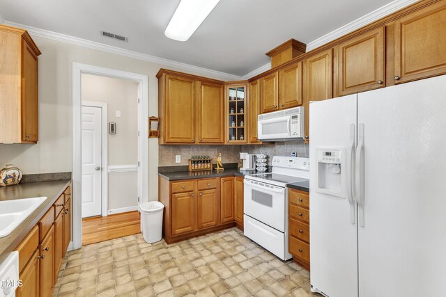 kitchen featuring visible vents, brown cabinetry, crown molding, white appliances, and glass insert cabinets