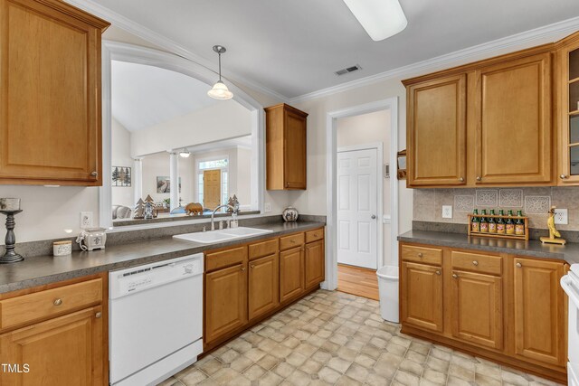kitchen with dark countertops, visible vents, a sink, and dishwasher