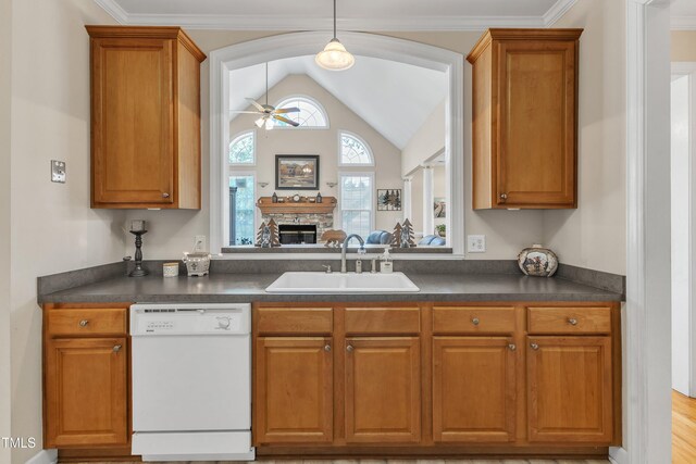 kitchen with a sink, dark countertops, a ceiling fan, and dishwasher