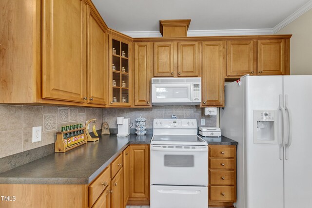kitchen with white appliances, backsplash, dark countertops, and ornamental molding