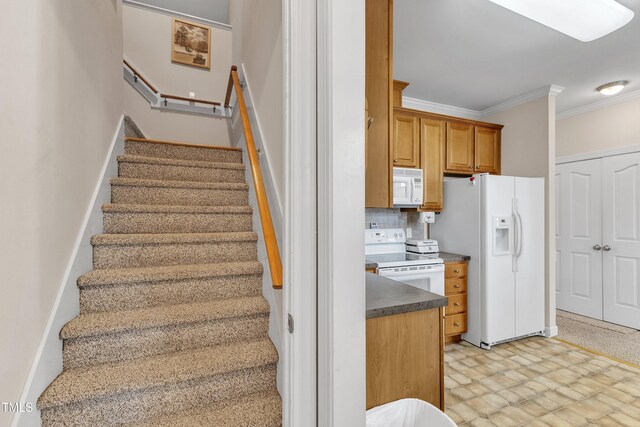 stairs with crown molding and tile patterned floors