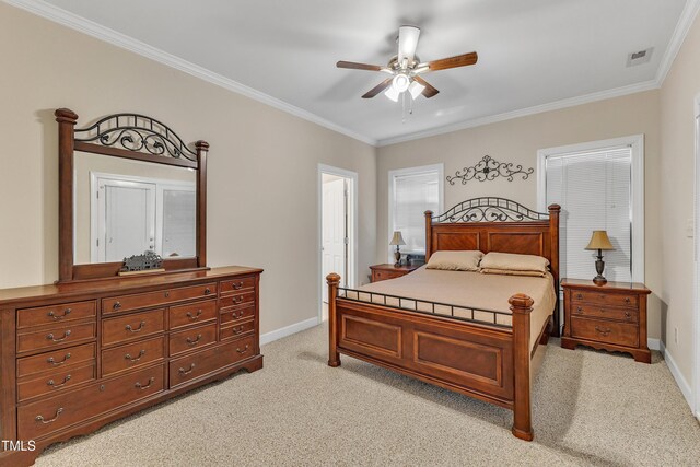 bedroom with crown molding, light colored carpet, baseboards, and visible vents