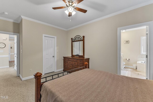 bedroom featuring crown molding, baseboards, light colored carpet, a ceiling fan, and ensuite bath