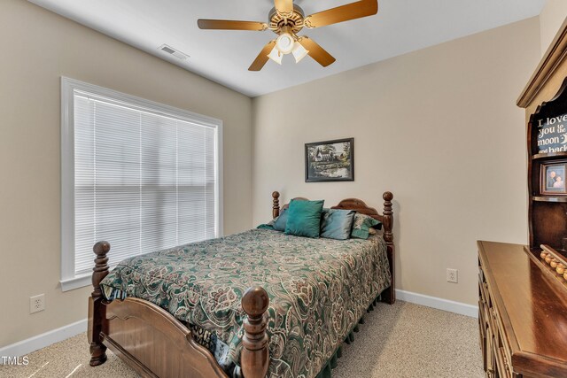 bedroom featuring visible vents, carpet flooring, baseboards, and a ceiling fan
