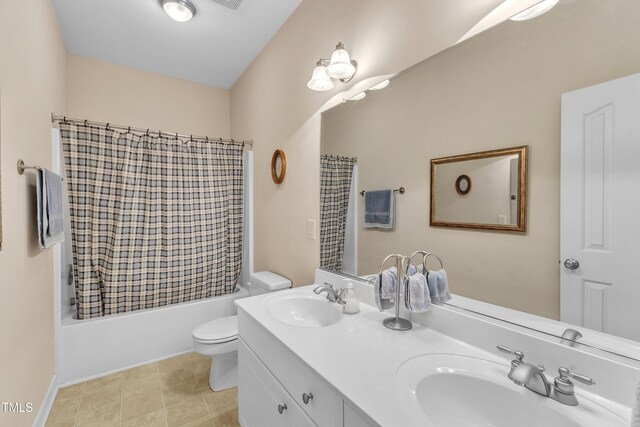 full bath featuring a sink, shower / bath combo with shower curtain, toilet, and double vanity