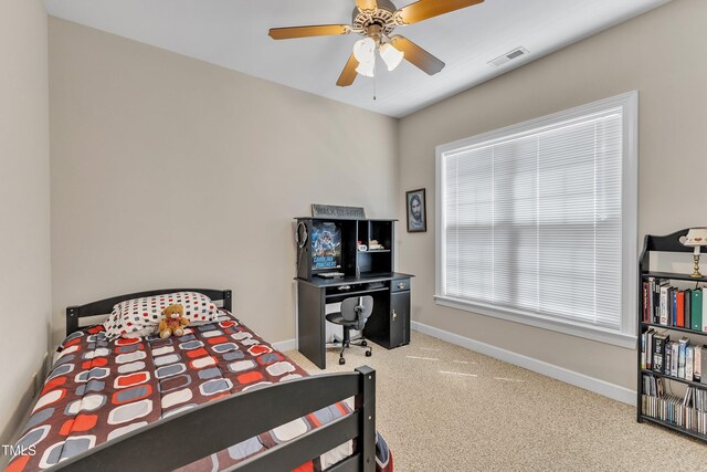 carpeted bedroom featuring baseboards, visible vents, and ceiling fan