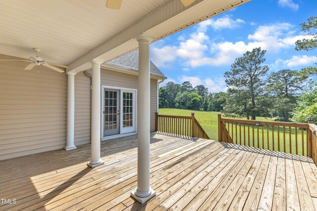 wooden terrace featuring a lawn and a ceiling fan