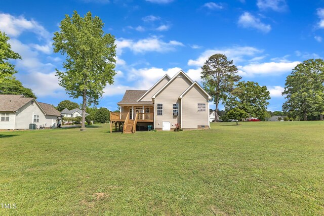 back of house featuring a lawn, central AC, a wooden deck, and stairs