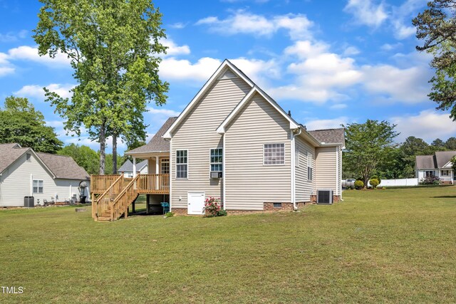 view of side of property with stairs, a lawn, a wooden deck, and crawl space