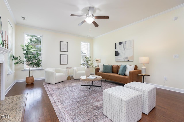 living area with ceiling fan, visible vents, baseboards, wood-type flooring, and ornamental molding